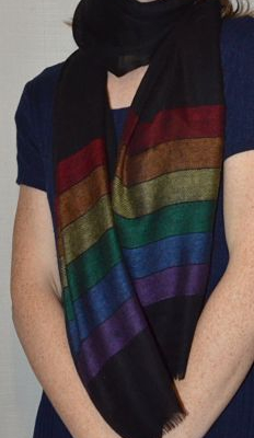 Empar is wearing our Diversity Pride shawl, black with rainbow stripes at the narrow edges. 100% pashmina!